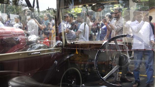 People photograph one of the vintage cars on display. (Hemanshi Kamani /HT Photo) 