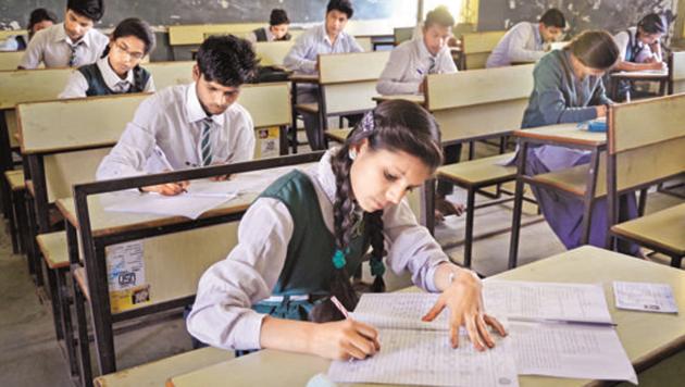 Students taking their board exams at a school in Bhopal. The CBSE said it has always relied on schools to depute experienced teachers for evaluation work. (HT File Photo)