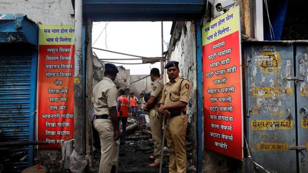 Policemen stand guard outside the damaged site after a fire broke out at a snack factory in Mumbai on December 18, 2017. The victims, who were declared dead on admission at Rajawadi hospital in Ghatkopar, have not yet been identified. (Danish Siddiqui / REUTERS) Policemen stand guard outside the damaged site after a fire broke out at a snack factory in Mumbai on December 18, 2017. The victims, who were declared dead on admission at Rajawadi hospital in Ghatkopar, have not yet been identified. (Danish Siddiqui / REUTERS)