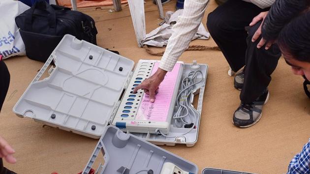 Polling officials checking the electronic voting machines (EVMs) in Ahmedabad on December 13. (PTI Photo) Polling officials checking the electronic voting machines (EVMs) in Ahmedabad on December 13. (PTI Photo)