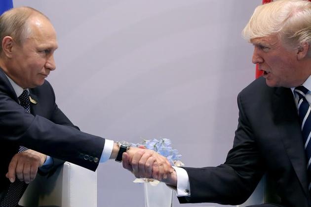 File photo of US President Donald Trump shaking hands with Russian President Vladimir Putin during the their bilateral meeting at the G20 summit in Hamburg, Germany, on July 7, 2017. (Reuters) File photo of US President Donald Trump shaking hands with Russian President Vladimir Putin during the their bilateral meeting at the G20 summit in Hamburg, Germany, on July 7, 2017. (Reuters)