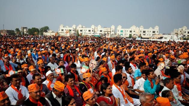 BJP supporters attend a campaign meeting addressed by PM Narendra Modi ahead of state assembly election on December 8, 2017. A win for the BJP would reinforce its dominance and affirm Modi’s popularity. For the Congress, a favourable outcome would be the best start Rahul Gandhi can hope for as new party chief. It will also mark a resurgence for the party, hit by a string of defeats, ahead of the 2019 general elections. (Amit Dave / REUTERS)