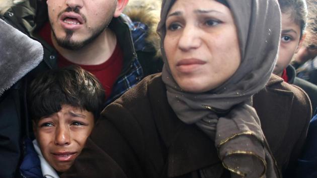 A Palestinian boy cries as he waits for a travel permit to cross into Egypt through the Rafah border crossing after it was opened by Egyptian authorities for humanitarian cases, in the southern Gaza Strip, on December 17, 2017. (Reuters)