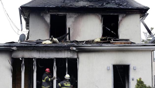 Firefighters inspect the scene of a fatal fire in the Brooklyn borough of New York. (AP Photo) Firefighters inspect the scene of a fatal fire in the Brooklyn borough of New York. (AP Photo)