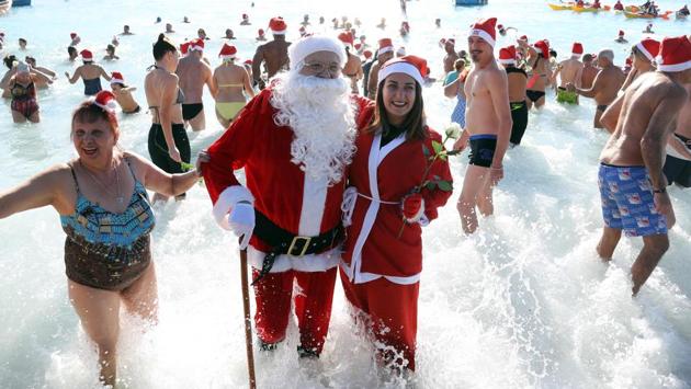 He tried his best in a crowd of stocking caps, but Santa’s long flowy beard gave Mr. and Mrs. Claus away during a quick trip to the French Riviera in Nice, France. (Valery Hache / AFP)