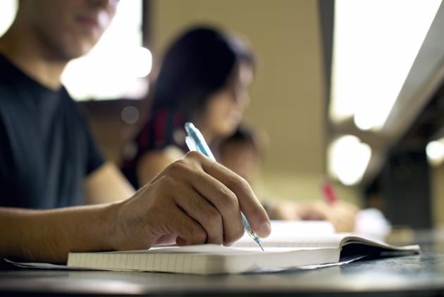 "Students doing homework and preparing exam at university, closeup of young man writing in college library"(Getty Images/iStockphoto) "Students doing homework and preparing exam at university, closeup of young man writing in college library"(Getty Images/iStockphoto)