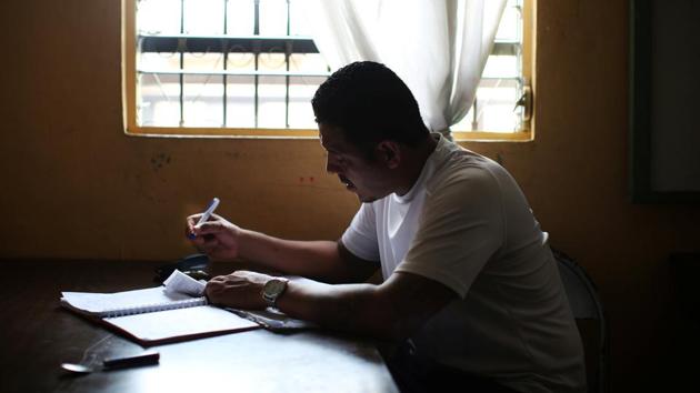 Wilfredo Gomez, 40, joined a gang as an adolescent in LA, enticed by guns, girls and the camaraderie of gang life. Jailed and deported back to El Salvador, he quickly returned to gang life. A 10-year jail sentence for stealing an Uzi gave him time to reckon with his choices. He now handles accounts for the bakery at the Eben Ezer church and is a member of the “Huellas de Esperanza” (Traces of Hope) ministry. (Jose Cabezas / REUTERS) 
