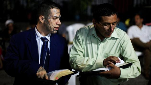 Julio Marroquin, (L), member of the Huellas de Esperanza ministry, participates in a religious service at the Eben-Ezer church in the gang-ridden Dina neighbourhood of San Salvador. Returning to civil society is arduous in the midst of the government’s militarized battle against the “maras,” which has led to claims of rights abuses and, according to police, an average daily tally of 16 dead. (Jose Cabezas / REUTERS) 