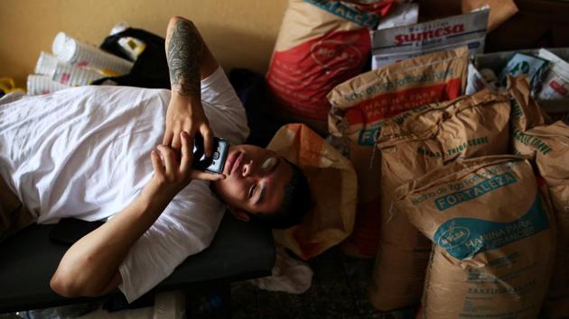 A member rests at the bakery at the Dina neighbourhood. In October, police went to the bakery and stripped the employees to expose their gang tattoos. They were arrested on suspicion of illicit association, a crime that carries a 5-year sentence. A week later, they were released without charges. (Jose Cabezas / REUTERS) 
