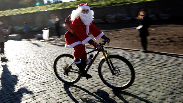 Santa brought out his newest ride as he joined hundreds of cyclists out on the streets of Rome, Italy. (Tony Gentile / REUTERS)