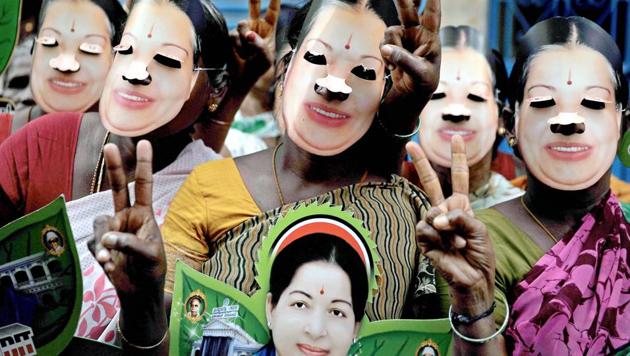 AIADMK supporters wearing masks embossed with the image of late CM J Jayalalithaa while seeking votes for party candidate E Madusudanan at RK Nagar constituency on Monday.(PTI)