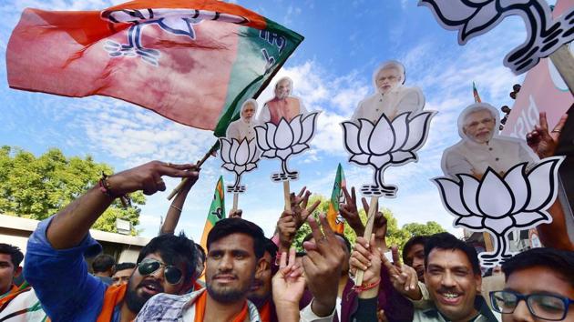 BJP workers in Gandhinagar celebrate their victory in the assembly elections on Monday. (PTI) BJP workers in Gandhinagar celebrate their victory in the assembly elections on Monday. (PTI)
