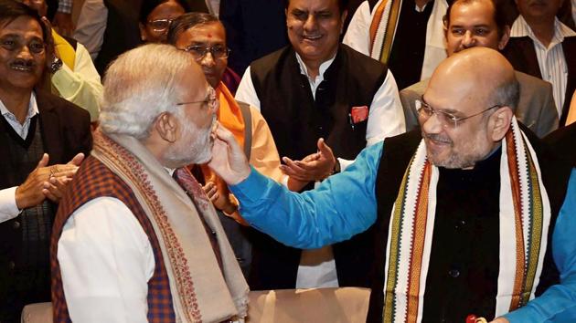 Prime Minister Narendra Modi being felicitated by BJP president Amit Shah after success in Gujarat and Himachal Pradesh Assembly elections during the Parliamentary board meeting, in New Delhi on Wednesday. (PTI Photo) Prime Minister Narendra Modi being felicitated by BJP president Amit Shah after success in Gujarat and Himachal Pradesh Assembly elections during the Parliamentary board meeting, in New Delhi on Wednesday. (PTI Photo)