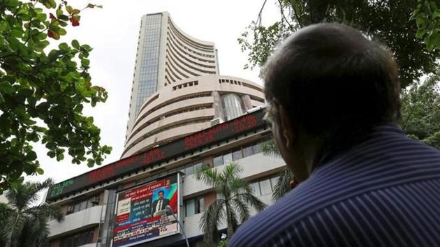 A man looks at a screen across a road displaying the Sensex on the facade of the Bombay Stock Exchange building in Mumbai. (Reuters File) A man looks at a screen across a road displaying the Sensex on the facade of the Bombay Stock Exchange building in Mumbai. (Reuters File)