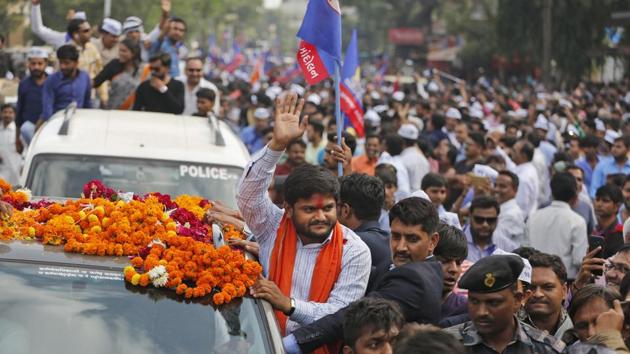 Hardik Patel waves to people during his road show in Ahmedabad on December 11, 2017. (AP Photo) Hardik Patel waves to people during his road show in Ahmedabad on December 11, 2017. (AP Photo)