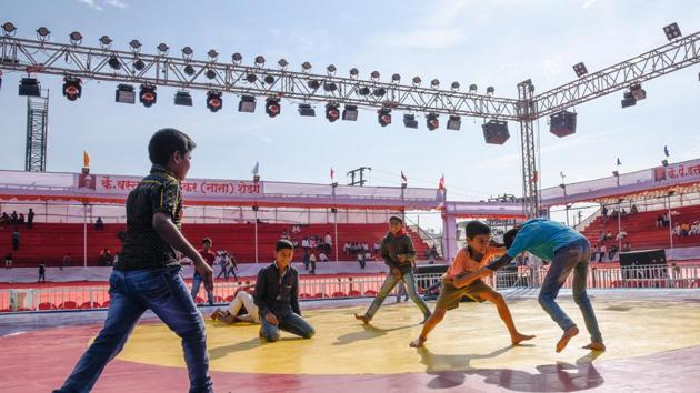 Children play on the wrestling mat at the venue in Bhugao. (Sanket Wankhade/HT PHOTO) Children play on the wrestling mat at the venue in Bhugao. (Sanket Wankhade/HT PHOTO)