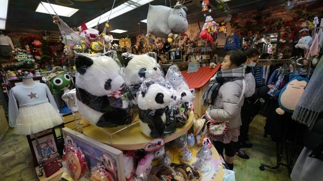 Customers browse through panda themed goods at a souvenir shop at Ameyoko shopping district near Ueno Zoo. “For me, the panda is the king of the zoo,” said Takamichi Masui, 50, who queued nearly three hours to be the first person to see Xiang Xiang. December 23 will be the first public holiday when large crowds are expected to turn up to meet the cub. (Shizuo Kambayashi / AP) Customers browse through panda themed goods at a souvenir shop at Ameyoko shopping district near Ueno Zoo. “For me, the panda is the king of the zoo,” said Takamichi Masui, 50, who queued nearly three hours to be the first person to see Xiang Xiang. December 23 will be the first public holiday when large crowds are expected to turn up to meet the cub. (Shizuo Kambayashi / AP)