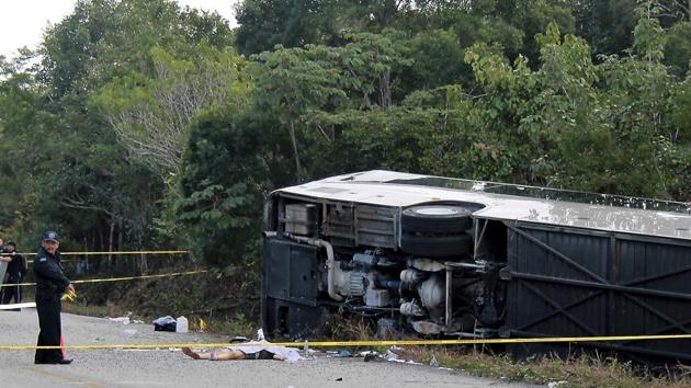 The lifeless body of a passenger lies next to an overturned bus in Mahahual, Quintana Roo state, Mexico on December 19 (AP Photo) The lifeless body of a passenger lies next to an overturned bus in Mahahual, Quintana Roo state, Mexico on December 19 (AP Photo)