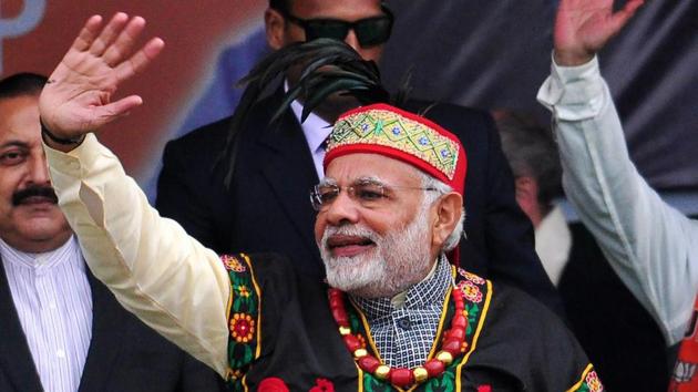 Prime Minister Narendra Modi dressed in traditional Khasi tribe attire and Garo tribe headgear, greets supporters in Shillong on December 16, 2017. (PTI Photo) Prime Minister Narendra Modi dressed in traditional Khasi tribe attire and Garo tribe headgear, greets supporters in Shillong on December 16, 2017. (PTI Photo)