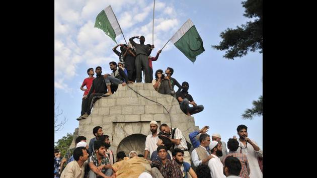 Kashmiri youth and journalists gather near the body of slain HM commander Burhan Wani during his funeral procession in his home town in Tral, 40 kms from Srinagar. Despite his young age, Wani had risen in the Mujahideen, becoming popular for his social media campaign aimed at drawing more youth to his cause. (Waseem Andrabi / HT Photo) Kashmiri youth and journalists gather near the body of slain HM commander Burhan Wani during his funeral procession in his home town in Tral, 40 kms from Srinagar. Despite his young age, Wani had risen in the Mujahideen, becoming popular for his social media campaign aimed at drawing more youth to his cause. (Waseem Andrabi / HT Photo)