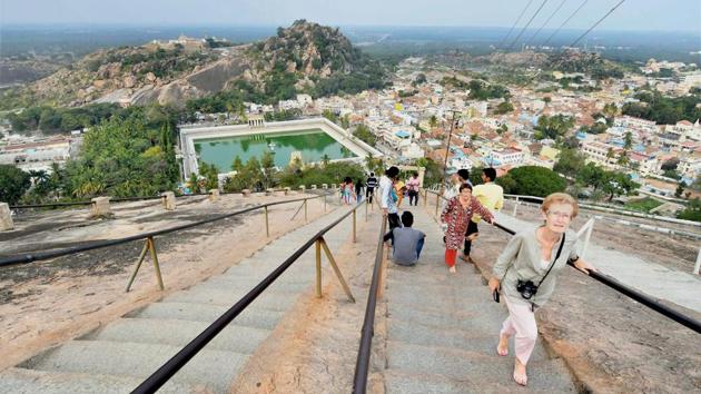 Tourists at the Gomateshwara statue site. The Mahamastakabhisheka of the Jain deity expects to draw as many as 2 million visitors from across the world to witness this colourful spectacle in 2018. (PTI)