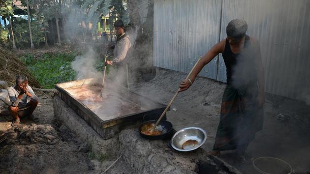 Rahim (L) looks on as his son Alamgir Sheikh (R), 21, boils cane sugar. After collecting the sap from the trees the process includes boiling, filtering and extensive stirring to make a thick paste that is cooled down to form jaggery. Also known as Gur, its production uses sap from four kinds of palm: palmyra, date, coconut and sago. (Diptendu Dutta / AFP) Rahim (L) looks on as his son Alamgir Sheikh (R), 21, boils cane sugar. After collecting the sap from the trees the process includes boiling, filtering and extensive stirring to make a thick paste that is cooled down to form jaggery. Also known as Gur, its production uses sap from four kinds of palm: palmyra, date, coconut and sago. (Diptendu Dutta / AFP)
