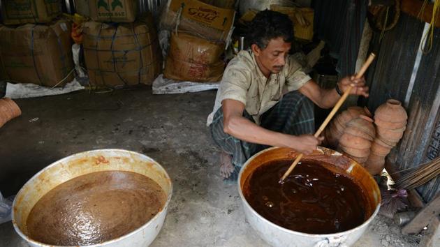 Rahim filters the boiled sap of the date palm tree. The jaggery made by these workers has found a market among locals and in various parts of North Bengal. When consumed in small quantities, jaggery is considered to have widespread health benefits, as is even gluten free. (Diptendu Dutta / AFP) Rahim filters the boiled sap of the date palm tree. The jaggery made by these workers has found a market among locals and in various parts of North Bengal. When consumed in small quantities, jaggery is considered to have widespread health benefits, as is even gluten free. (Diptendu Dutta / AFP)