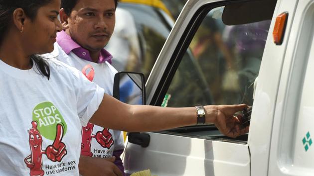 NGO volunteers distribute packets of condoms to drivers in Mumbai. (AFP) NGO volunteers distribute packets of condoms to drivers in Mumbai. (AFP)