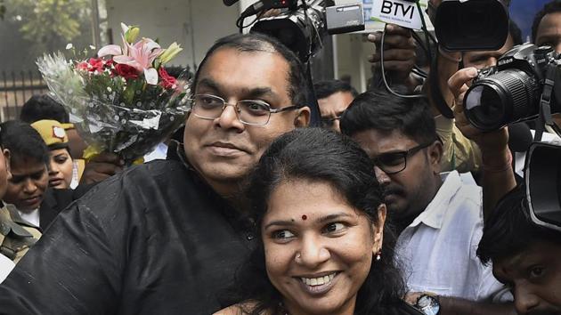 DMK MP Kanimozhi with her husband G Aravindan after she was acquitted by a special court in the 2G scam case, in New Delhi.(PTI Photo)
