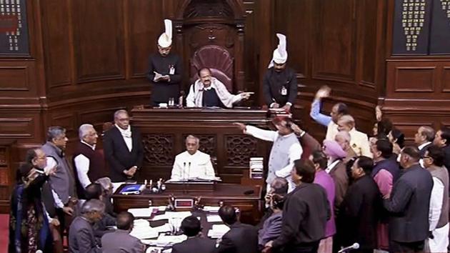 Opposition members protest inside the Rajya Sabha in New Delhi on Thursday during the ongoing winter session of Parliament. (PTI Photo) Opposition members protest inside the Rajya Sabha in New Delhi on Thursday during the ongoing winter session of Parliament. (PTI Photo)
