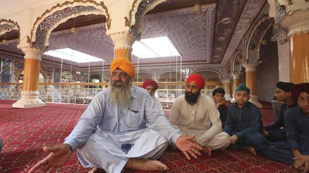 In this Tuesday, Aug. 8, 2017 photo, Pakistani Sikh Radesh Singh, left, talks at a temple in Peshawar, Pakistan. (AP File Photo) In this Tuesday, Aug. 8, 2017 photo, Pakistani Sikh Radesh Singh, left, talks at a temple in Peshawar, Pakistan. (AP File Photo)