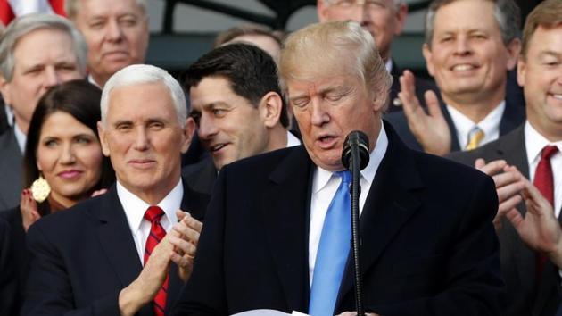 Vice President Mike Pence applauds US President Donald Trump as they celebrate passage of sweeping tax overhaul legislation at the White House in Washington on December 20, 2017. (REUTERS) Vice President Mike Pence applauds US President Donald Trump as they celebrate passage of sweeping tax overhaul legislation at the White House in Washington on December 20, 2017. (REUTERS)