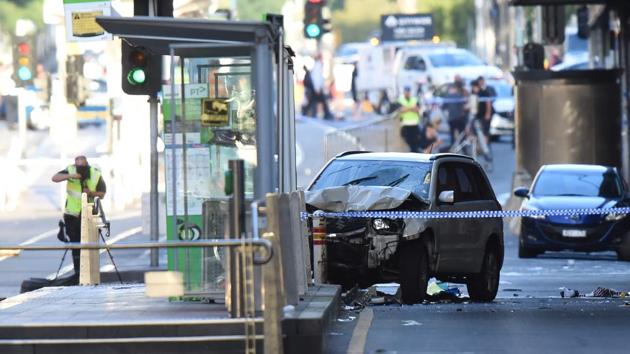 A white SUV (C) sits in the middle of the road as police and emergency personnel work at the scene of where a car ran over pedestrians in Flinders Street in Melbourne on December 21, 2017. (AFP Photo) A white SUV (C) sits in the middle of the road as police and emergency personnel work at the scene of where a car ran over pedestrians in Flinders Street in Melbourne on December 21, 2017. (AFP Photo)