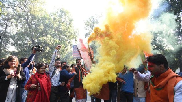 BJP workers celebrate at the party headquarters in New Delhi after winning both the Gujarat and Himachal Pradesh elections on Monday. (Sonu Mehta / HT Photo)