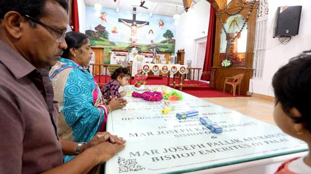 Pilgrims kneel at the tomb of St. Alphonsa at Bharananganam, Kerala. Alphonsa, a 20th century religious figure, became the first woman of Indian origin to be canonised in 2008, and is part of the trio of Christian figures fast becoming a big draw in the state. At her tomb, a priest guides tourists through the sprawling church complex, packed with pilgrims from across the country. (Vivek Nair / HT Photo) 