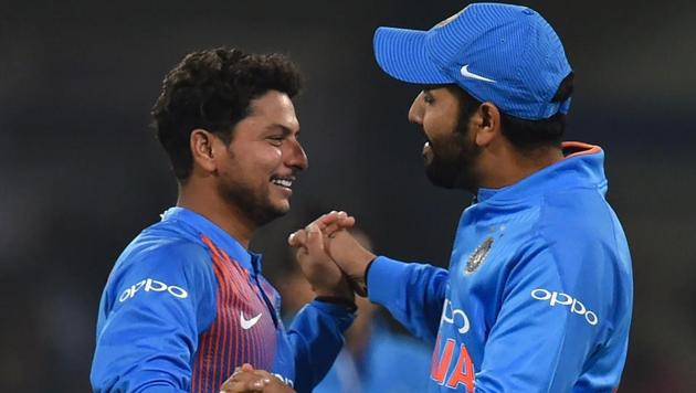Indian cricketer Kuldeep Yadav (L) celebrates with captain Rohit Sharma after taking the wicket of Kusal Perera during the second T20 international between India and Sri Lanka at the Holkar Stadium in Indore on December 22. Sharma said he was confident in both Yadav and Yuzvendra Chahal despite the spinners leaking runs early in the game.(AFP)