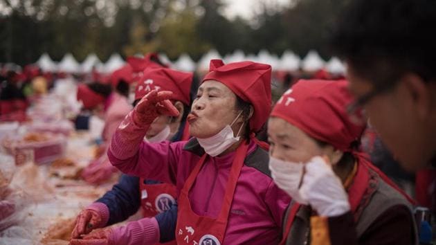 A woman tastes kimchi during a kimchi-making festival in Seoul. Kimchi is not the only cultural component that divides the Koreas. Seven decades of political and economic division have seen linguistic divisions emerge --North and South spell and pronounce some Korean words differently and especially loanwords from English, so much so that North Korean defectors are given language lessons as part of their assimilation course. (Ed Jones / AFP)