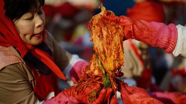 Kimchi is prepared during a mass winter kimchi-making event in Seoul, South Korea. North and South Korea differ radically, one ruled by the same family for decades and the other a freewheeling democracy and thrusting economy, but fermented cabbage unites them. Kimchi, originally a means of preservation during winter can vary from mild to fiery, but has been a staple of virtually every meal on the now-divided peninsula for centuries. (Ed Jones / AFP)