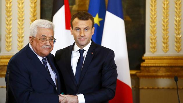 French President Emmanuel Macron shakes hands with Palestinian President Mahmud Abbas at the end of a joint press conference following their meeting at the Elysee presidential Palace, in Paris, on December 22. (AFP Photo) French President Emmanuel Macron shakes hands with Palestinian President Mahmud Abbas at the end of a joint press conference following their meeting at the Elysee presidential Palace, in Paris, on December 22. (AFP Photo)