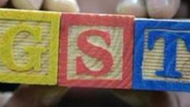 A trader shows letters GST representing "Goods and Services Tax" (GST)at his shop in Hyderabad on August 3, 2016. (AFP File Photo) A trader shows letters GST representing "Goods and Services Tax" (GST)at his shop in Hyderabad on August 3, 2016. (AFP File Photo)