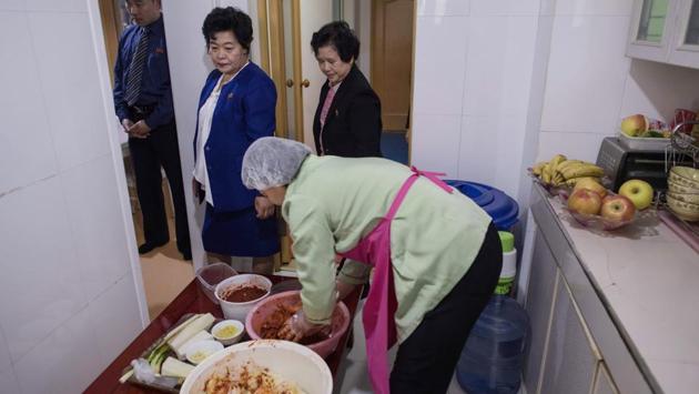 In Song’s flat, her cousin Yu Yang Hui (C) mixes sliced radish, garlic, pieces of pollack, and a red pepper paste, before spreading the concoction between cabbage leaves brined for 24 hours. Technological advances in the South such as specialised kimchi fridges and greater access to spices and condiments have made the North-South flavour gap more pronounced. Nevertheless, the kimjang or kimchi-making season remains a family tradition on both sides. (Ed Jones / AFP)