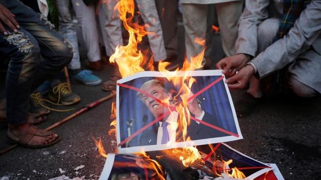 Protestors burn posters of U.S. President Donald Trump organised by various religious organisations against the U.S. decision to recognise Jerusalem as the capital of Israel on Sunday. (Adnan Abidi / REUTERS)