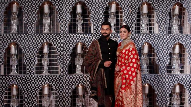 India's cricket team captain Virat Kohli (L) and his wife, Bollywood actress Anushka Sharma, pose during a photo-op at their wedding reception in New Delhi on Thursday. (Adnan Abidi / REUTERS)