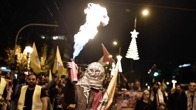 A man ignites an aerosol canister as Palestinians living in Greece protest US President Donald Trump's declaration of Jerusalem as Israel's capital, near the US embassy in Athens. (Louisa Gouliamaki / AFP) A man ignites an aerosol canister as Palestinians living in Greece protest US President Donald Trump's declaration of Jerusalem as Israel's capital, near the US embassy in Athens. (Louisa Gouliamaki / AFP)