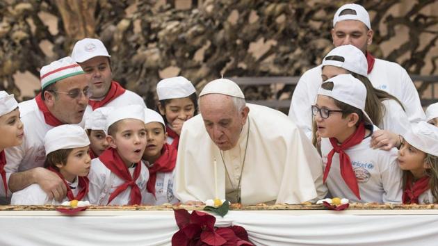 Pope Francis blows out a candle on a pizza on December 17, 2017 during an audience with children assisted by "Dispensario Santa Marta", a Vatican pediatric clinic at the Vatican. Pope Francis celebrated his 81st birthday on December 17, 2017. (Osservatore Romano / AFP) Pope Francis blows out a candle on a pizza on December 17, 2017 during an audience with children assisted by "Dispensario Santa Marta", a Vatican pediatric clinic at the Vatican. Pope Francis celebrated his 81st birthday on December 17, 2017. (Osservatore Romano / AFP)