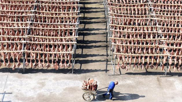 A worker pulls a cart filled with Jinhua ham at a ham-processing facility in Jinhua, Zhejiang province, China on December 18, 2017. (William Hong / REUTERS) A worker pulls a cart filled with Jinhua ham at a ham-processing facility in Jinhua, Zhejiang province, China on December 18, 2017. (William Hong / REUTERS)