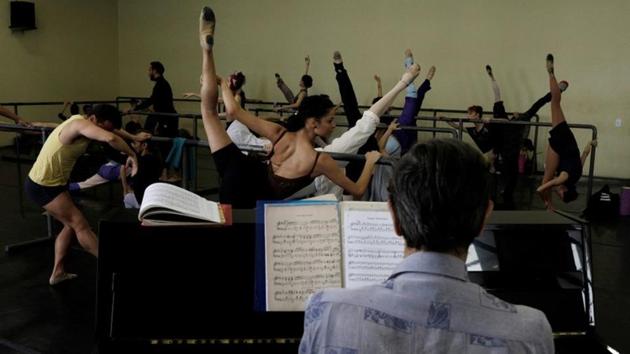 Dozens of dancers continue to attend exacting rehearsals and refine their craft with each leap and pirouette. But they say insufficient sleep as they work multiple jobs and lack of money for expenses like ballet pointe shoes, physical therapy and nutrition regimens is taking its toll. (Ricardo Moraes / REUTERS) Dozens of dancers continue to attend exacting rehearsals and refine their craft with each leap and pirouette. But they say insufficient sleep as they work multiple jobs and lack of money for expenses like ballet pointe shoes, physical therapy and nutrition regimens is taking its toll. (Ricardo Moraes / REUTERS)