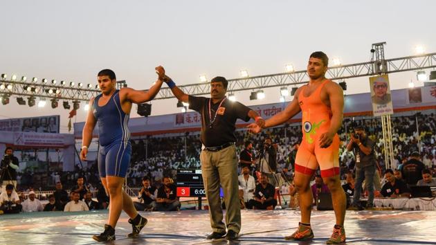 Abhijit Katke(blue) of Pune beats Ganesh at Maharashtra Kesari tournament held at Bhugao in Pune on Friday. (Sanket Wankhade/HT PHOTO) Abhijit Katke(blue) of Pune beats Ganesh at Maharashtra Kesari tournament held at Bhugao in Pune on Friday. (Sanket Wankhade/HT PHOTO)