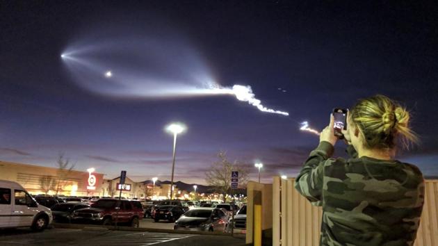 A woman photographs the light display of SpaceX's Falcon 9 rocket launch on Friday in Apple Valley, California. The launch was more than 200 miles from Apple Valley yet was still brilliantly visible. The Falcon 9 booster lifted off from coastal Vandenberg Air Force Base, carrying the latest batch of satellites for Iridium Communications. (AP) A woman photographs the light display of SpaceX's Falcon 9 rocket launch on Friday in Apple Valley, California. The launch was more than 200 miles from Apple Valley yet was still brilliantly visible. The Falcon 9 booster lifted off from coastal Vandenberg Air Force Base, carrying the latest batch of satellites for Iridium Communications. (AP)
