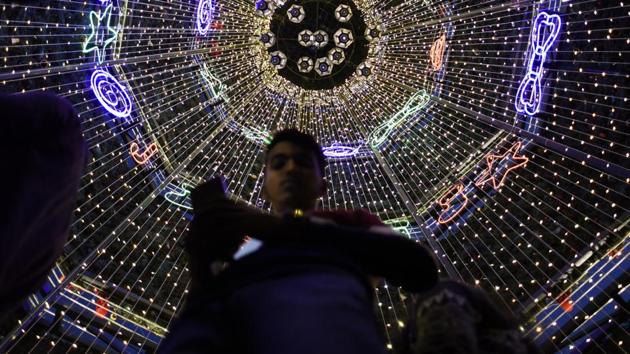 People take photographs in front of a Christmas tree at a mall in New Delhi. (Photo by Burhaan Kinu / Hindustan Times) People take photographs in front of a Christmas tree at a mall in New Delhi. (Photo by Burhaan Kinu / Hindustan Times)